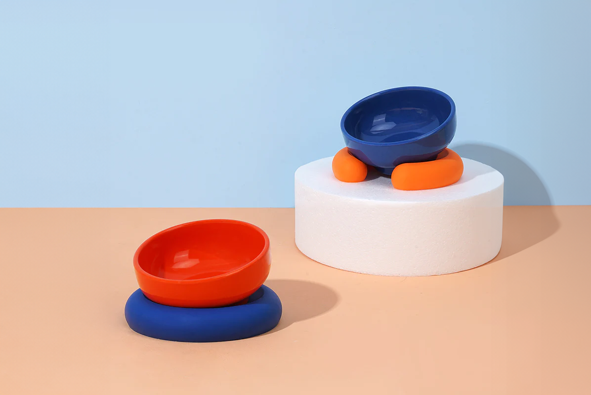 Two colourful titled feeding bowls for pets